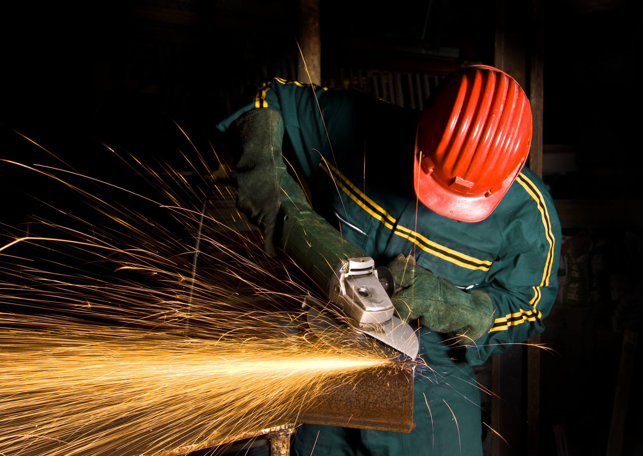 man using angle grinder for finishing processes